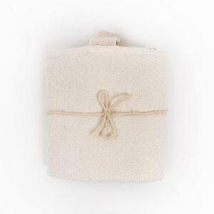 Big white linen towel neatly folded with a tied string for display.