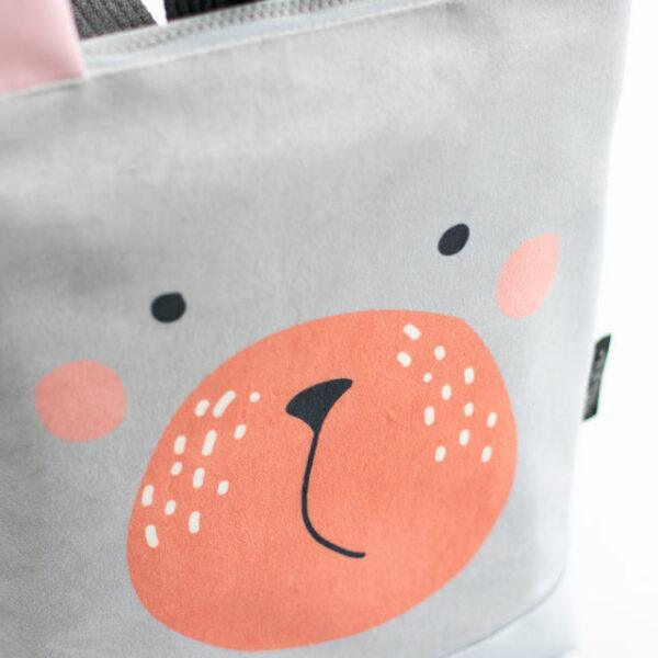 Kids backpack with a cute bear face design for children.