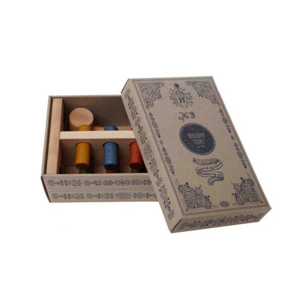 Colorful wooden pounding bench with mallets in a decorative box.