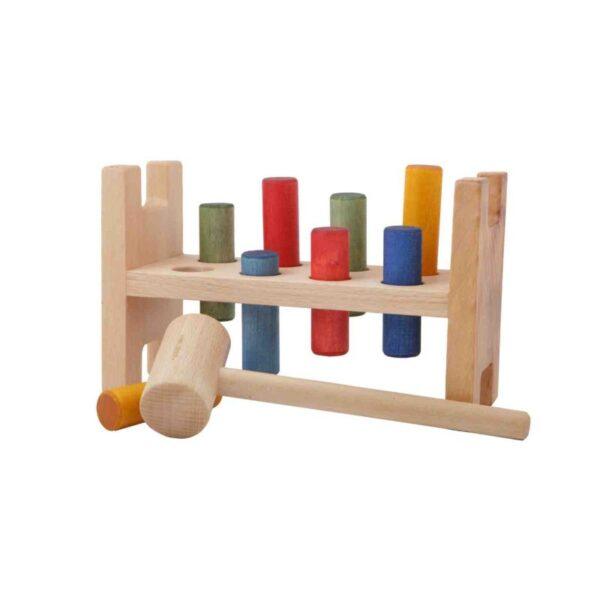 Colorful wooden pounding bench for children with mallet and pegs.
